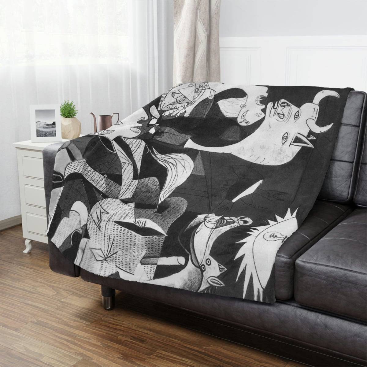 Pablo Picasso Guernica Art Blanket draped over a sofa