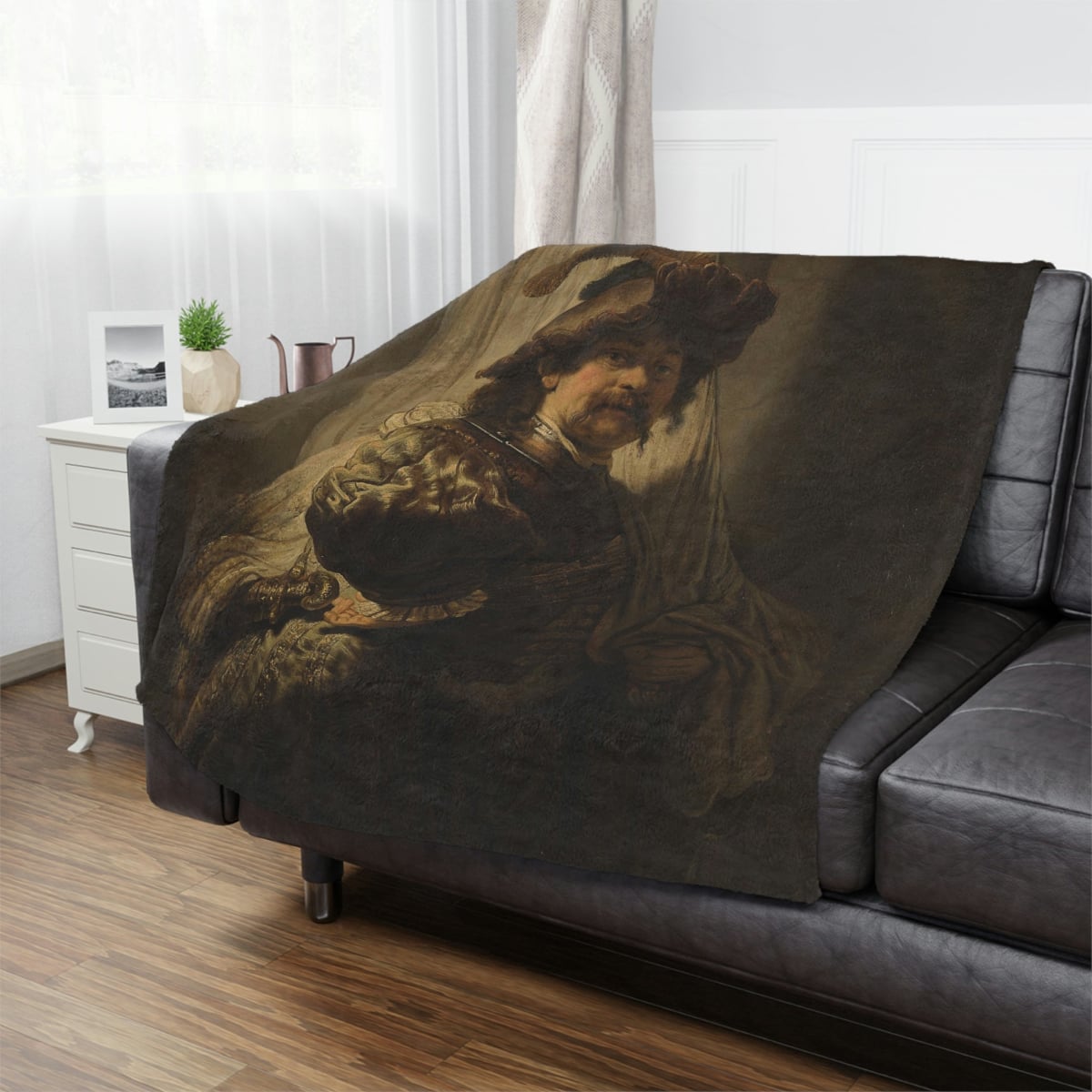 Elegantly styled 'The Standard Bearer' Rembrandt Art Blanket on a cozy sofa